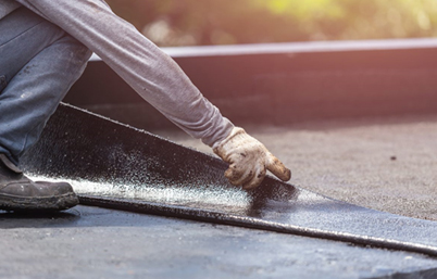 man of roof making repairs